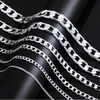 Silver chain necklace on a black background 
